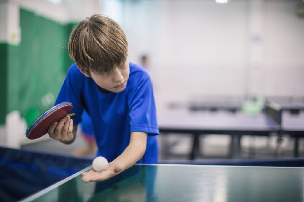 Boy playing table tennis