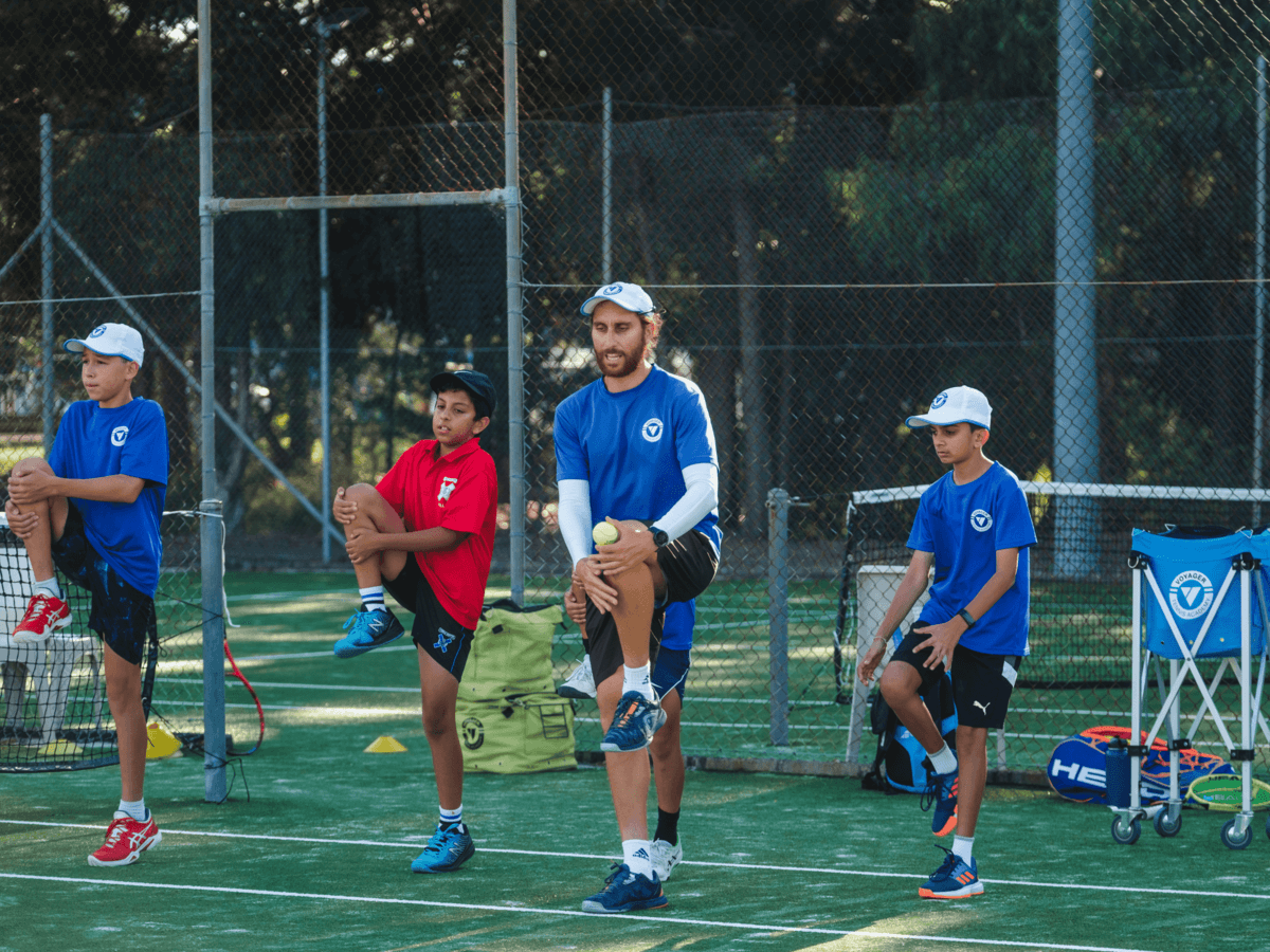 Group coaching setting with kids learning drills