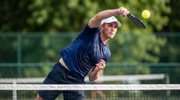 A man doing a smash in pickleball